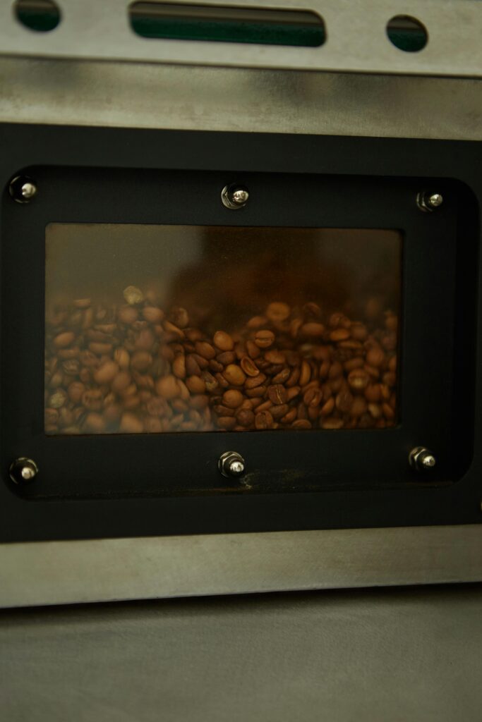 Freshly roasted coffee beans in a professional roasting machine.